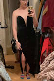 The green is darker than it looks in the listing photos which I like I think it looks very elegant. The slit is very high but I plan to pin it a little lower. Has elastic around the bust to prevent slipping. - Riley M.