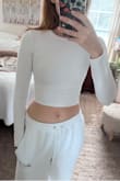 I bought this shirt in size small in both white and brown color. The brown fit great, but the white was TINY. Like, skintight tiny. I decided to return it and order the medium. The medium is a little bit better, but still absolutely skintight in the body, like compression legging. I'm pretty thin, with not much happening in the boob area and I don't have a belly, so this was surprising to me. I'm going to see if the large comes back into stock in the next few days and see if I can exchange it. The model has to be wearing a big size in white because it looks deceptively loose on her. In the pic I'm wearing the medium.

Other than the sizing issue, it's a cute shirt! It's not see-through at all which is nice. - Suzy W.