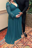 I wore this dress at 9 months pregnant, literally about to pop! I received so many compliments. The dress fit good, but was very low cut. I ended up getting it altered a little for a more comfortable fit. Size medium. - Diana R.