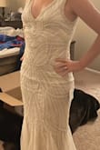 I loved this dress as soon as I put it on! It fits like a dream. It is fun, flirty, and elegant at the same time. The beading was absolutely beautiful, but made the dress appear less white. It appears more silver in person. This is a great find! - Janine R.