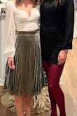 I originally ordered a size Small and exchanged it for an XS. I am 5'4", 125lb, athletic build and found even the XS to be very small for the type of high-waisted fit I was expecting/wanted. I wound up using safety pins to achieve the fit I wanted (didn't have enough time to get it professionally altered before an event) and the material was extremely forgiving to my DIY fix (couldn't tell it was pinned). I love this skirt and will get it altered and rewear it in the future! - Bevin B.