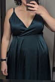As others stated in their reviews, the dress needed alterations in the bust. I also found that it puckered a bit between the center of each boob and the armpit area. After sewing up the middle, some of the puckering went down, but still didn't fit 100% as I would have liked. I ordered the emerald green and as others stated, it had more of a jade green hue to it. Length was a little long in <1" shoes, but definitely fine for the night. I usually wear a 16 and ordered a 1X which fit perfectly around the waist.
I included photos of the dress as it came and after my friend helped sew the dress - Robin S.