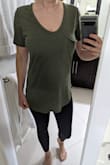 I have a couple of these shirts already and they are long, but this one is particularly long. Definitely a tunic on me. I can tie it up and it's fine, but it looks a little ridiculous if I wear it down because it comes all the way past my butt in the back. Otherwise, the material is soft, breathable, and not see-through. Good basic, I just wish it was 2 inches shorter. 5'4", 130 lbs, 34D, 27" waist, purchased size small. - Lindsey F.