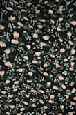 I was shocked when I received this dress as it isn't just black and cream. The print has peach/orange and green in it too! It fits nicely, but I would not have ordered it if I had seen a close-up of the material. - Kathy F.