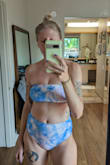 I love this suit. Super cute and the colors are as bright as the picture. The small fit well but I have gone with the medium. They aren't a super high waist. The top reaches right below my belly button. I do wish the sides were a little less bulky. It's definitely more full coverage and I think there could have been a sexier cut instead. - Holly R.
