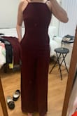 The fit is flattering. I bought both a medium and a small and the medium was definitely too big. The small fit perfect. I didn't notice this but it has pockets! My butt looked great. I felt like the crotch was a little low from the front but only I noticed- I got a ton of compliments. Wore with 4 inch heels and the length was good, looks like the length on the model. The straps are a little weird and I thought would fall but honestly I had no issues. I wore it to a holiday party and plan to wear it again to a black tie wedding ceremony with a blazer. - Raleigh T.