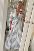 Definitely buy a size down. I'm usually a small, bought an xs. But definitely buy it! The most comfortable item I own. I get the most compliments from it. It's just exactly what you were looking for. But just size down. This was before I steamed it, but it is absolutely worth the purchase. - Nicole W.