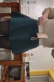 I wore this skirt with a lulus top for my final presentation at college and I loved it. The skirt fits well and isn't super short (it is short but I wasn't flashing everyone I was presenting to). There is a little space in the waist when wearing it but it didn't fall down. There is a little bit of pilling, but it's not impacting the way it looks. It is a slightly thicker material but overall I love it and want one in every color. - Isabella S.