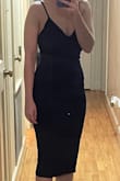 I got this for my graduation! It felt true to size. It has some stretch to it but is form-fitting. I was comfortable while wearing it. The front chest does have a seam across the nipple line so I would recommend using a strapless bra to round out that area if you're relatively flat but if you have more shape in your bust you could probably get away without wearing a bra. - Brittney W.