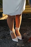 The material is great! So soft and smooth. I feel like the wrap-around straps are a bit awkward but they still look great overall! With the wrap-around not being tied, it does make the heel lift from the back when you walk. But overall I am content with the purchase. - Cindy C.