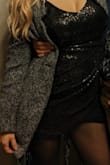 I bought this black dress in a size medium for NYE. I received so many compliments when I wore it. What I like about this dress is that I was able to adjust the straps and that it was flattering. Also,  the v neck shape is not super revealing and the dress is a bit shorter in the front. The zipper is in the back and seems to blend in with the dress. I would say that the dress hugs your body.  I paired this dress with sparkly earrings, black tights, tall black boots, and a coat. I recommend this dress. - Maria C.