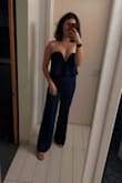 I love this jumpsuit!! 98% of my wedding guest attire is jumpsuits these days, but this one might be a new favorite. I have no curves on my lower half but found the fit of this jumpsuit to be very flattering. I kept it fully zipped all night as it is stretchy enough to just pull up and down easily, so don't have to worry about having someone constantly help you zip up.  I am a 34C and easily was able to go braless as well, so it's about as comfortable as it gets! - Amanda C.