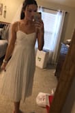 This dress is cute and fits nice, wearing for my wedding shower. However in certain lighting the metallic pattern gets washed out in photos - Emily B.