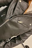 It's definitely a more loose-fitting jacket but slightly shorter than an average leather jacket so gives your hips a good shape. I'm REALLY glad I sized up to M, I can fit a sweater under it tightly. Hoping this material holds up - Natasha B.