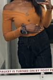 This shirt is the perfect amount of cute, but also a tad sexy. Sits perfectly on the shoulders and you don't have to worry about fixing it. I'm usually a small and kept with my size. When I first tried it on I was scared the arms were a little tight (I like to strength train), but the second time I put it on to wear it for the night, it fit perfectly - Aisha R.