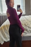 Absolutely LOVE this top! I love the peekaboo back that shows my back tattoo. The sleeves are the perfect length. I ordered a small and it is well fitted to the body but super soft and stretchy. I don't wear it with a bra, but if you have a bra with wider straps and that sits low on the back, it could work. In the photo, I tucked the shirt under slightly to show off the joggers! But it hits about one inch above my hip, so a slight crop. - Farin J.