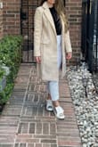 It's great. Exactly as pictured. I'd prefer it [to] have a little more fitted waist but it allows for a sweater underneath so it's great. Moderate weight. Beautiful. - Megan P.