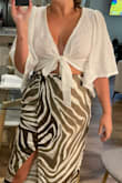 The top is a tad see-through but you can't see much. I liked the fit and the tie is awesome for all chest sizes. Great for summer vacays! Will be wearing it again this summer - Michelle M.