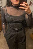 Bought a small. A slight bit on the itchy side. The colored sparkles are beautiful (they are not embedded in the fabric, fyi). The bodysuit is a tad on the "short" side; I didn't think my torso was that long, but this piece said otherwise. Overall, a stunning piece. - Maddie K.