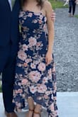 This dress is so stunning!!! The asymmetrical neckline and flowy high/low skirt combination is super unique and very flattering. The material feels high quality and the colors really pop.  I wore this to an outdoor late-summer wedding and even though it was super hot, this breezy dress kept me comfy and earned lots of compliments! The bodice is surprisingly snug in a supportive way, so even though I chose to wear an adhesive bra for additional support, I could have gotten away without one, which is rare for me (the back is slightly too low for a strapless on me).  Can't wait to wear it again! - Mari S.