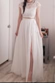 I bought this set knowing I would likely not wear the top, but wanted this skirt for my wedding ceremony. The only reason I did not give this 5 stars is because the top runs a bit short under the bust. The skirt is very romantic and the slit is not too dramatic, but makes it easy to walk in. It just hits the floor in 4 inch heels and that is how I want it. Be cautious about sizing. I bought a xs because I am a 25 waist, it fits, but it just nearly fits. The zipper went all the way up, but no wiggle room. I like the "sash" style at the very top. It is a good transition for whatever top you're wearing with it. Cropped or not. The back of the top is very elegant. I really did like how it zipped all the way up the back. Nice lace detailing and scalloped edges, too. - Kiana G.