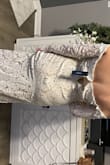 I wanted to love this dress so much and it was a pretty dress but the zipper wouldn't work correctly. Even off of me, it kept snagging and would need to be redone by a seamstress. it was also odd around the top as the flowers at the top looked like they needed to be trimmed off and you definitely could not raise your hands at all in this dress as it was very restrictive. - Danielle D.