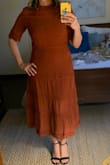 True fit. I noticed some of the reviews said the material was cheap, I disagree. I can see how it could rip along the zipper if you're not careful. Bought the color for a wedding color palate & I can't wait to wear it. Husband loved as well! - Pam H.