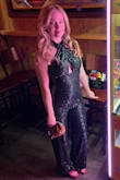 I loved wearing this jumpsuit. The material is very forgiving and flattering. I used sticky bra petals to support the girls and keep them in place. It is extremely long in the legs. I'm 5'3 and wore 3 inch heels, and I STILL had to have 3 inches cut off and hemmed professionally. I couldn't hem it myself bc of the liner fabric and how the leg cuff is constructed. So if you're under 5'9, set some money aside for professional alterations. Outside of that inconvenience, I had so much fun wearing it and got tons of compliments!! - Shelley M.