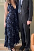 The dress fits really well and looks exactly like it does in the picture. It lays well on the chest, lower cut without being too revealing. The fabric was resistant to wrinkling too, I packed it in a duffle and didnt have to steam or anything before my event! - Erin S.
