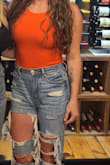 I LOVE this bodysuit! The color is awesome - it's a reddish-orange that really pops! I love the higher neckline and the lower scoop back, which adds a little fun to the outfit! It runs a little small, I have a bigger chest and have to use double-sided tape to hide my bra straps but it's easy to fix that! I probably would have sized up if I knew but you really can't tell when I'm wearing it that it's a little tight. Looks great with high-waisted relaxed jeans. - Melissa A.