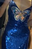 I originally found this dress when I was looking for a blue butterfly dress to match my new blue butterfly cowgirl boots to wear to an upcoming concert. When I saw this dress I knew it was literally meant to be because of how perfect it is so of course I bought it. The all-over sequins are gorgeous and I LOVE the butterfly in the middle. The back is also beautiful I love the cross tie back since the original measurements are a bit loose for me but I can adjust and make it more fitted with the ties. The front does go a little low, not to where I'm scared I'm gonna flash someone but it definitely is a cleavage dress, so do know that if you get worried about that kind of stuff. I literally love this dress so much though and will definitely be getting more use out of it besides the concert-like dances and parties!!! - Kylie G.