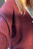 This is not the color shown in the photo. The real color is maroon. My husband called it "grandma's sweater". He even said that he could smell moss from grandma's closet as a joke. I am keeping it because it is lightweight and warm. I am going to wear this around the house. - Elisabeth L.
