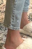 Model is listed to be taller than me by a couple inches. In the picture, the jeans appear way more high waisted, and they actual fit the entire length of her leg, they end just around her ankle. On me, they are just a couple inches too short which makes no sense because I'm shorter than her. I think the photos are edited and it just doesn't appear the same lengths. I ordered a size 5. Jeans were super comfy and fit perfectly otherwise, would order again if they provided longer lengths. - Natalie T.