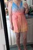 The color is gorgeous. The top fits looser than expected. I wish it was more fitted looking like on the model. The lining shows under the arms. Overall, it is a cute romper and I will be wearing it on vacation. - Jessica B.