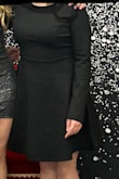 It's lined and the outer material has some stretch. Fits nicely. On 5'4" it hits at the knee. - Laina S.