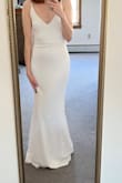 This dress is long but can easily be hemmed. I like that at my height, it kind of creates a small train. It has a snug fit but is still comfortable. The straps are adjustable but it made it look a little cheap. So I plan to alter the straps and take the adjustable piece out. I got the dress so I could take honeymoon photos in it on vacation. - Julie G.