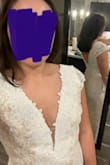 I bought this dress as my backup wedding dress. It's beautiful and fit so well, I just didn't love it more than another dress I found. I am small chested so there was a bit of a gap. I would have definitely needed some tape to keep things together. The little fabric in the slit was completely beneath my breasts. Another review said the cloth was yellow stained, but it is white lace over a nude-colored dress. I have big hips/butt and it fits great with stretch. At 5/2, the dress was definitely maybe 4 inches too long. - Elizabeth Q.