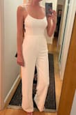 Material is nice and thick, not see-through whatsoever, the low back is beautiful. The top doesn't leave a ton of support so you may need some sort of bra if you're busty. Also, the straps are not super supportive but will do fine if you don't need a ton of support. I bought this for my casual rehearsal dinner and will wear it with a white scarf. I'm 5'10 and the jumpsuit just touches the ground, I planned to wear flats anyways so it works. Very comfy and a great find for the price. - Lindsay P.