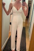 I really love the style but the pant fabric, while thick, feels cheap looking. It's pretty snug on the top as the other review mentioned but I'm a 34C and it fits really well and gave good support. I think if your upper body frame is on the petite side this would look nice. The zipper is tough and would be difficult to manage solo. I bought this potentially for my rehearsal dinner but I'm going with the other jumpsuit I purchased on Lulus given the fabric looks nicer and may end up returning this one. - Lindsay P.