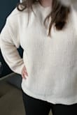 Super cozy and soft material. Sleeves are bell sleeves so they do get in my way slightly when trying to accomplish some tasks around the house so definitely consider this a sweater to lounge around the house in and chill. I got a medium (am usually either a medium or a large) and this is slightly oversized so fits great. - Kelly L.