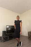 This dress is lined and fits very well! It gives all the drama but keeps you covered and the length was great! I recommend this dress for cocktail hour or any semi-formal or after 5 event. The shoes will help dress it up or down. - Brigette M.