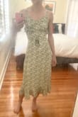 Overall a pretty and classy dress. The flowers on the green dress are a little more yellow than I expected. It's fully lined and well constructed. The dress looks fancier than I expected, something that would be perfect for an outdoor event like a winery or a casual wedding but maybe a little fancier than I'd wear day-to-day. I don't love the buttons, they look a little cheap but that's a pretty minor issue. There's a hidden side zip to help you get in and out.
I have a long slender torso and big hips for my size, but the cut of this dress fit well and flattered my pear shape. I look a lot more hourglass in it. Ladies who are shorter or rather busty might have fit issues. There is some extra room at the waist as you can see in my second pic so it still might work for you if you're not quite so slender there, but the tie waist holds back the extra material nicely if you are. - Christine L.