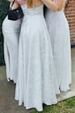 Bought this beautiful gown for my daughter's sorority presentation. I bought seven different white gowns in total from five different companies, but this one was the best. So glad it worked as it was a final sale purchase. My daughter wore it with 3-inch sandals, and at 5'7" the gown just skimmed the ground. It really needed about a 1/2-inch alteration but with a small platform on the shoe, it would have been perfect.  It has a nice slimming fit and the material doesn't wrinkle much. It looked lovely. - Anita N.