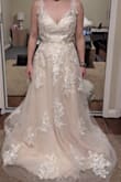 Beautiful dress, simple and right amount of lace. I love that it doesn't have a long train. If you have a longer torso, the back will fit you better than me. I did return it but I recommend it for others! - Kacie Y.