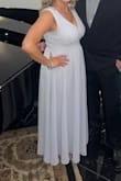 The dress was beautiful.
I did have to have it hemmed a couple inches. I wore a 3 inch heel.
and had the shoulders lifted a couple inches. I'm not one that likes her 
boobs on display. - Michelle A.
