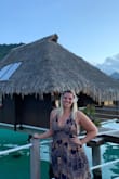 Wore this on our trip to Tahiti and received many compliments. The dress was a little long and I am 5'9 but I chose to wear flats still. I did need to pick it up at times so I wouldn't step on it while walking. Dress is open back so you can't wear a bra but you can tie it tighter around the neck which helps. Loved this dress. - Vanessa S.
