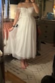 Got this dress for my bridal shower and I absolutely love the fit and feel! It's gorgeous and the material is great albeit a little itchy on the bust. Had to dock off one point for the zipper though, it keeps getting stuck. Paired it with a tulle bow veil to complete the look! - Ashley D.