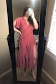 This is the second time I have bought this dress, this time in pink. The first one was burgundy and it came with rips under the ruffles. You can't see them and it didn't affect the dress so I still wear it. It fits incredibly well and I get so many compliments. I've been eyeing the pink one up for the while and it came without rips so its perfect. I want one in every color now! - Becky D.