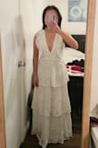 It's a cute dress and touches the floor without heels for me. I'm returning because my arms look big in this. The v-neck is pretty secure once you zip the dress up. - Hailey D.