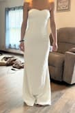 I love the material and the fit of this dress but I ended up going with another dress that had straps. It's stretchy and shows your curves you didn't know you had. Prettier in person I think. - Delanie S.